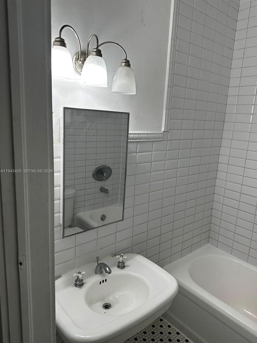 4116 Southwest 13th Terrace Miami, FL 33134 - Photo 5 of 8 a bathroom with a sink a toilet and bathtub