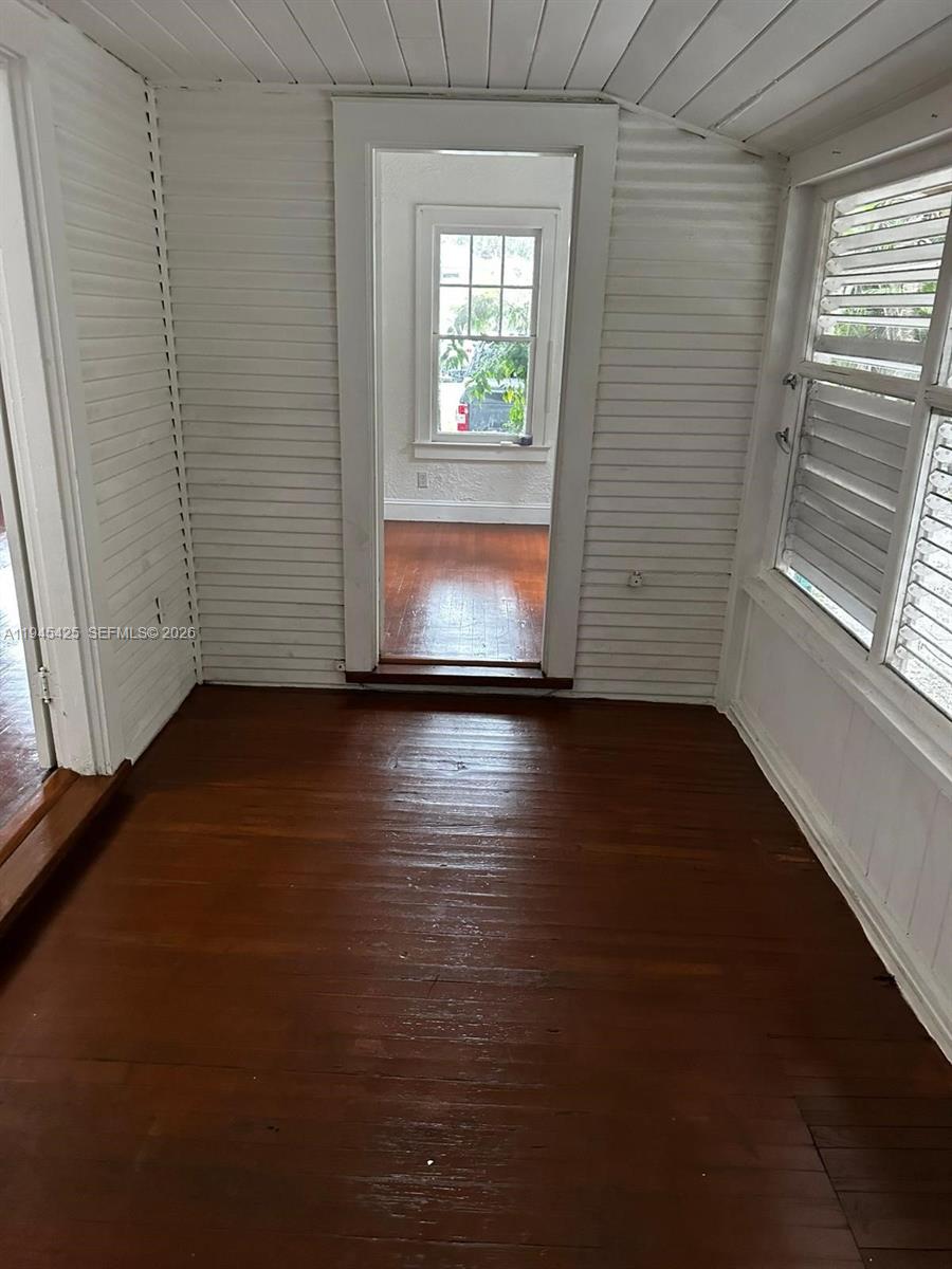 4116 Southwest 13th Terrace Miami, FL 33134 - Photo 6 of 8 an empty room with wooden floor and windows