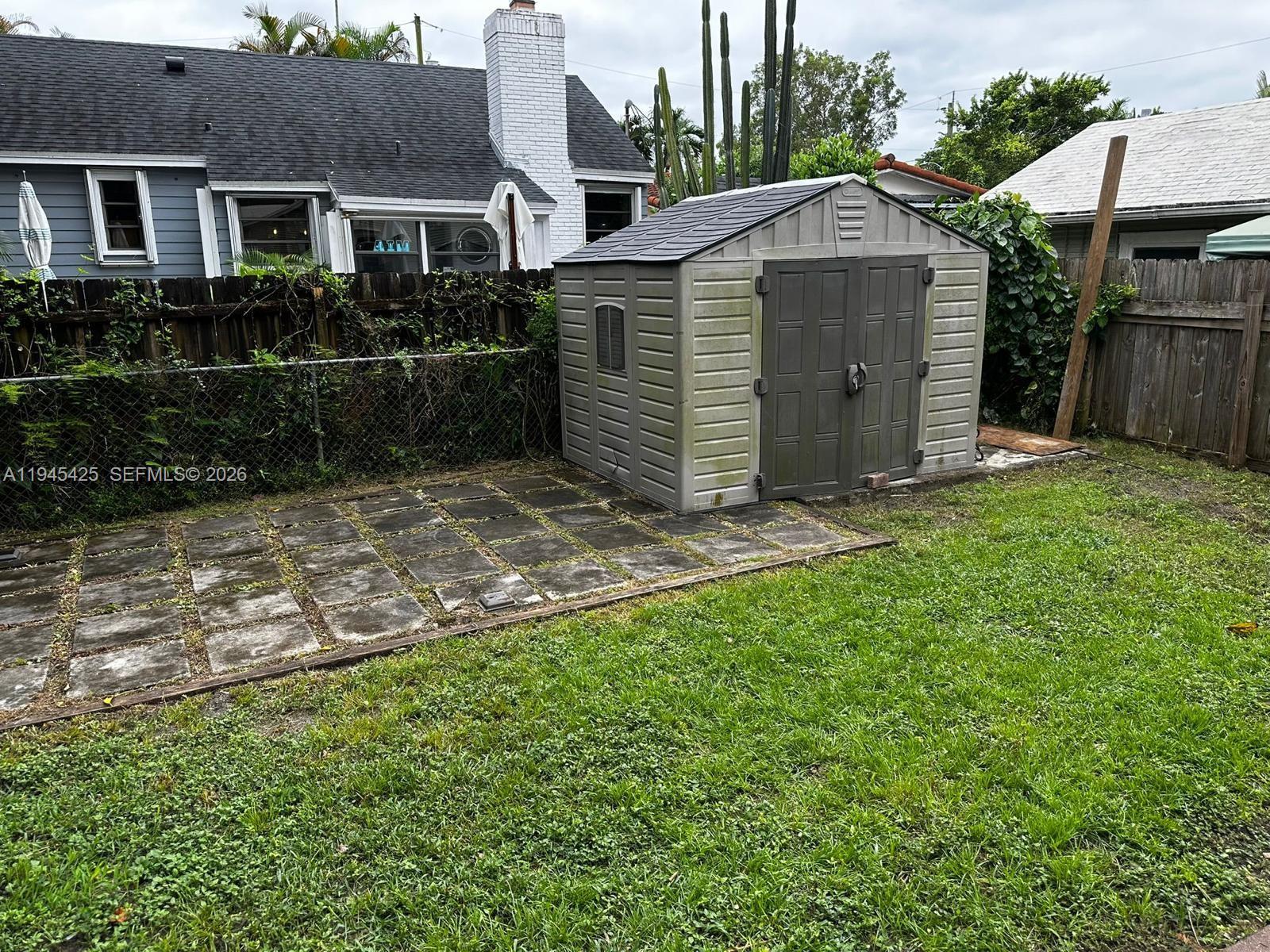 4116 Southwest 13th Terrace Miami, FL 33134 - Photo 8 of 8 a view of a house with a yard and fence