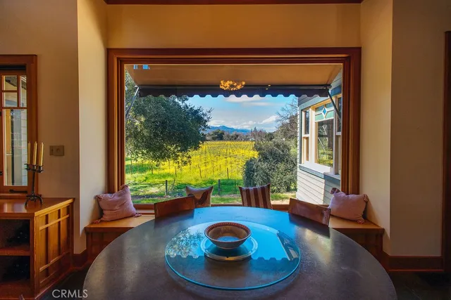 a view of a dining room with furniture wooden floor and a chandelier