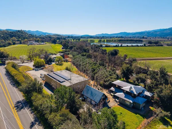 an aerial view of a house with yard and roof