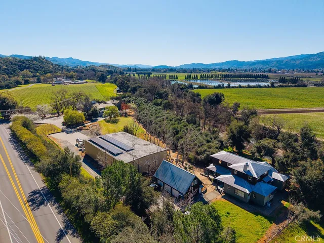 an aerial view of a house with yard and roof