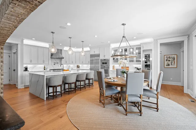 a large kitchen with a table and chairs