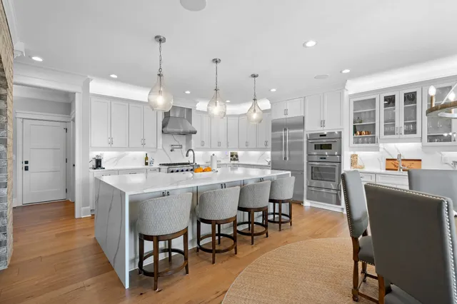a large kitchen with a table and chairs