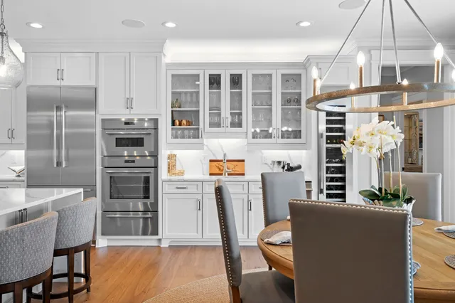 a kitchen with stainless steel appliances granite countertop a refrigerator and a stove top oven