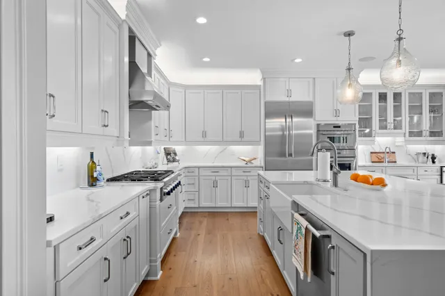 a kitchen with stainless steel appliances granite countertop a stove and cabinets