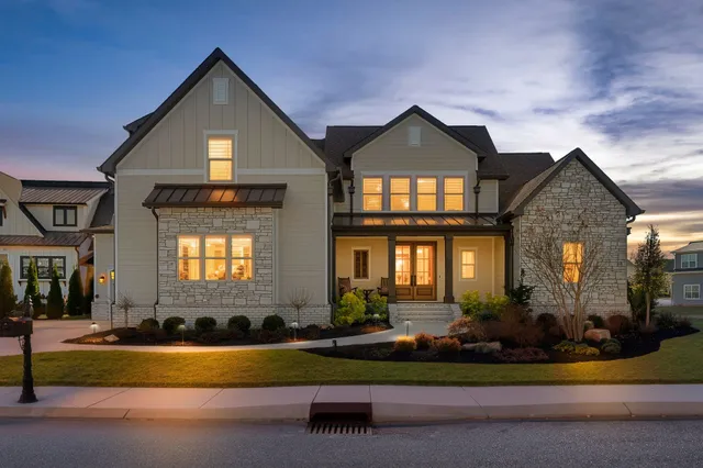 a front view of a house with a garden and plants