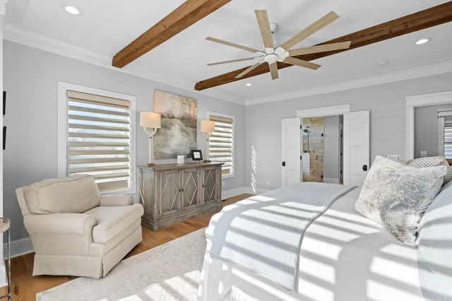 a bedroom with furniture and a large window