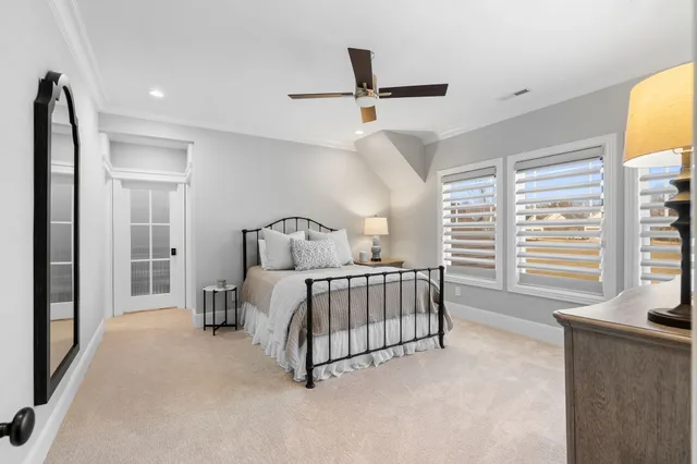 a bedroom with a bed next to a window