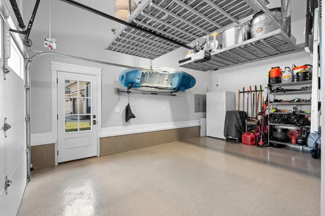 a view of a patio with table and chairs potted plants and floor to ceiling window