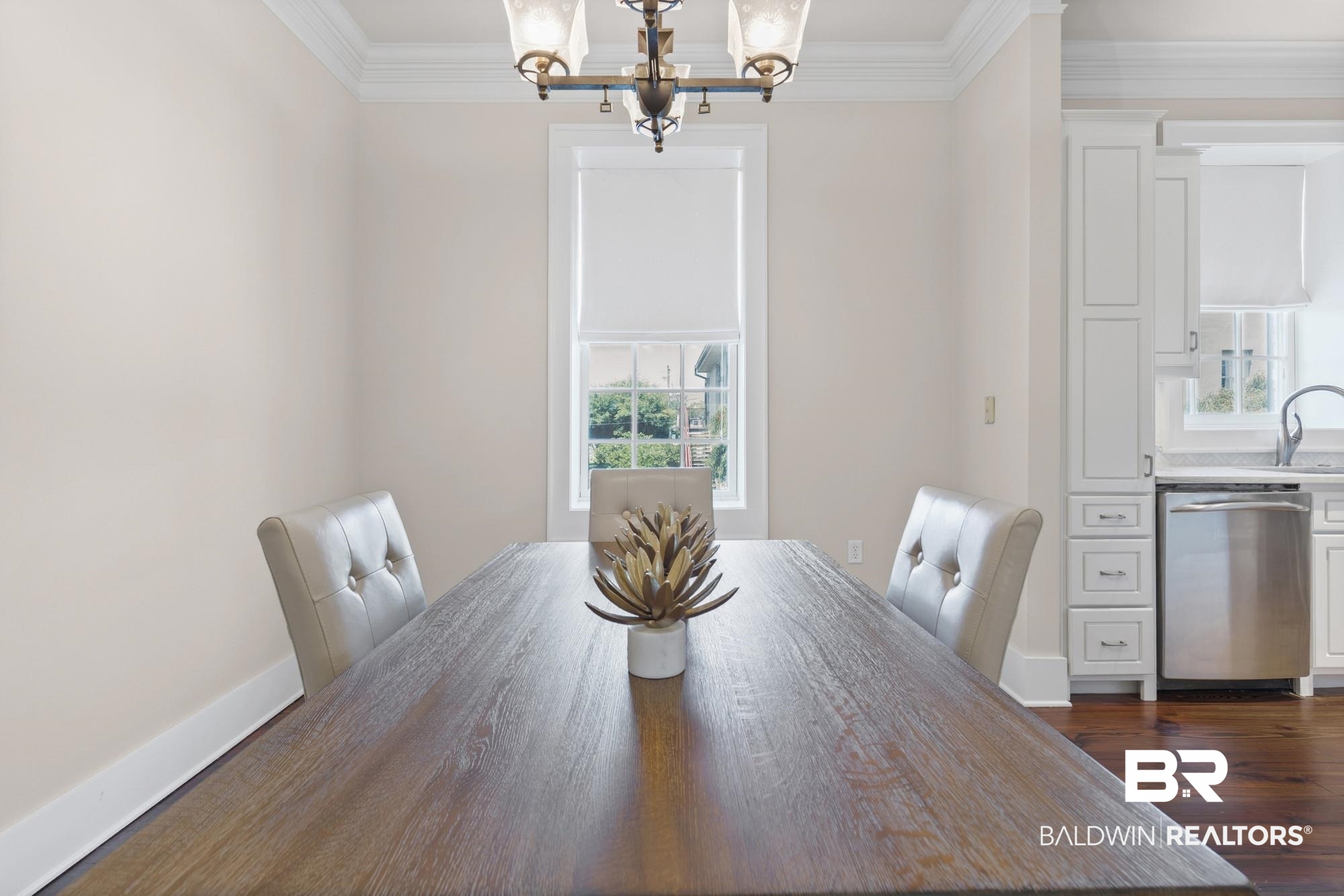 701 Dauphin Street, Unit A Mobile, AL 36602 - Photo 11 of 31 Dining area featuring wood-finish flooring, a contemporary chandelier, and crown molding