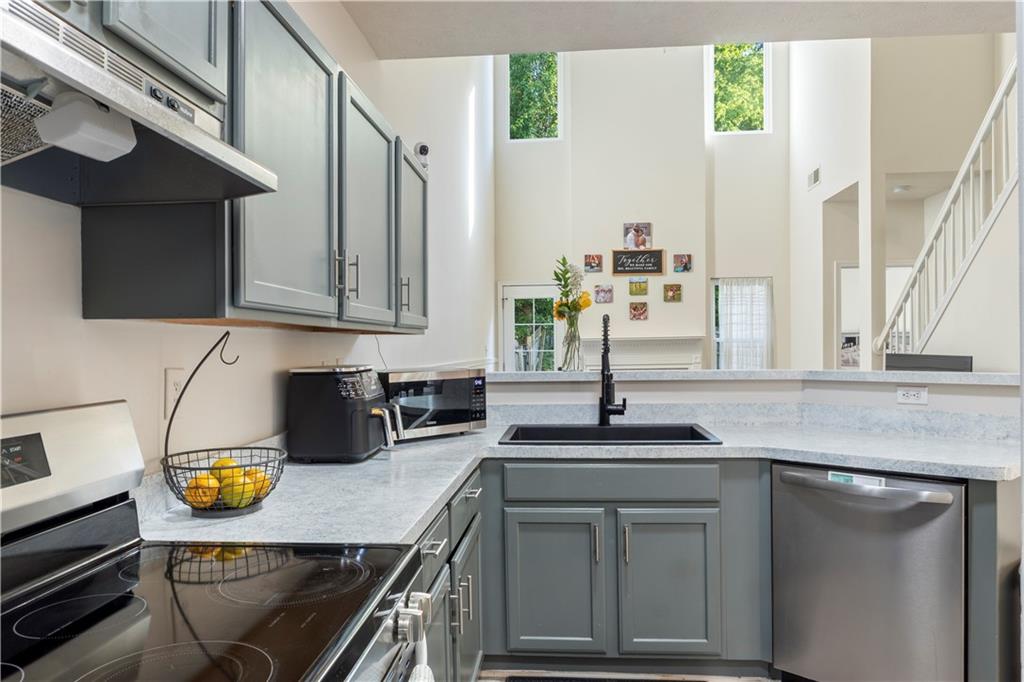 48 Hampton Drive Cartersville, GA 30121 - Photo 6 of 29 a kitchen with stainless steel appliances granite countertop a sink a stove and a microwave