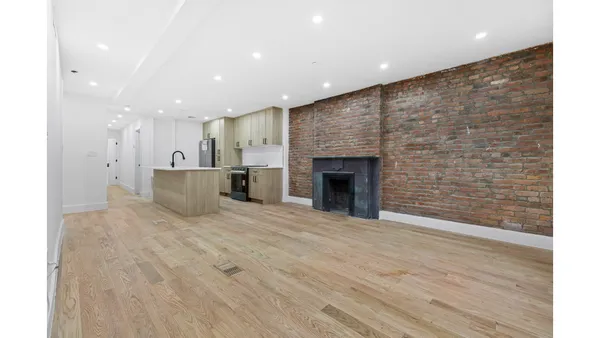 a view of an empty room with a fireplace