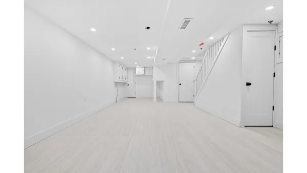 a view of an empty room with stairs