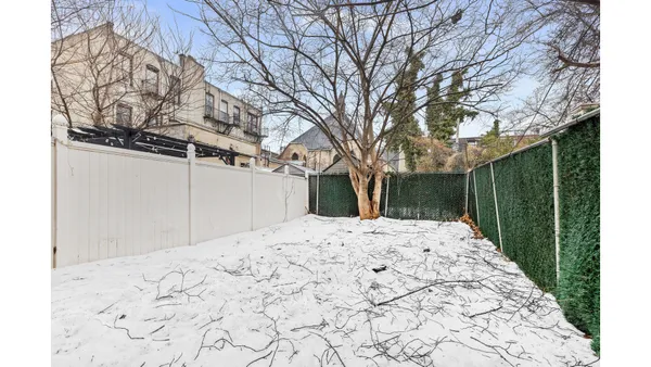an empty room with a kitchen and a sink