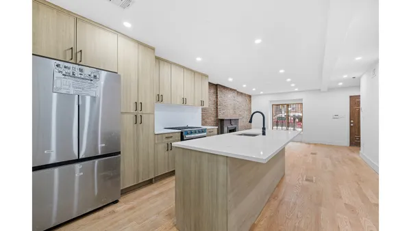 a view of an empty room with a fireplace and a window