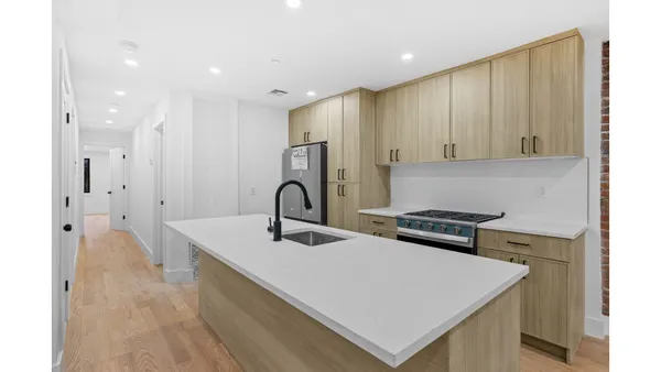 a view of kitchen with refrigerator sink and wooden floor