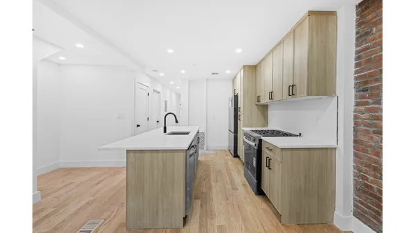 a kitchen with stainless steel appliances granite countertop a sink a stove and a refrigerator