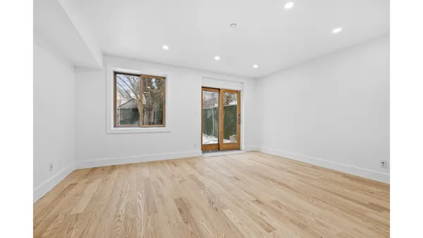 a kitchen with stainless steel appliances granite countertop a sink a stove and a wooden floors