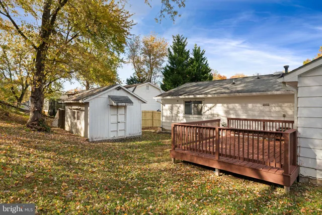 a view of a yard with wooden fence