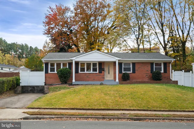 a front view of a house with yard porch and tree