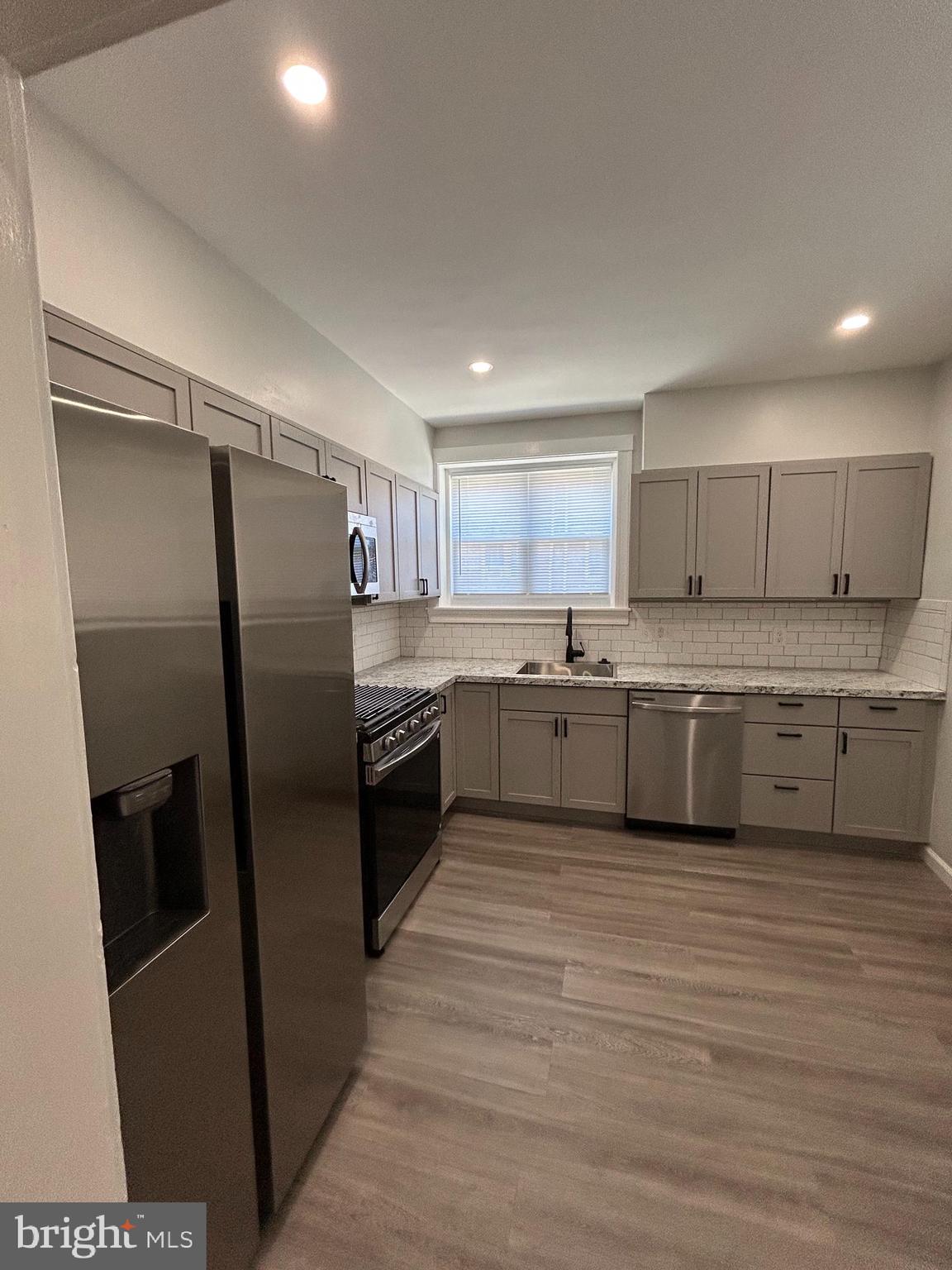 46 Lamport Road Upper Darby, PA 19082 - Photo 14 of 33 a kitchen with stainless steel appliances a refrigerator sink and cabinets