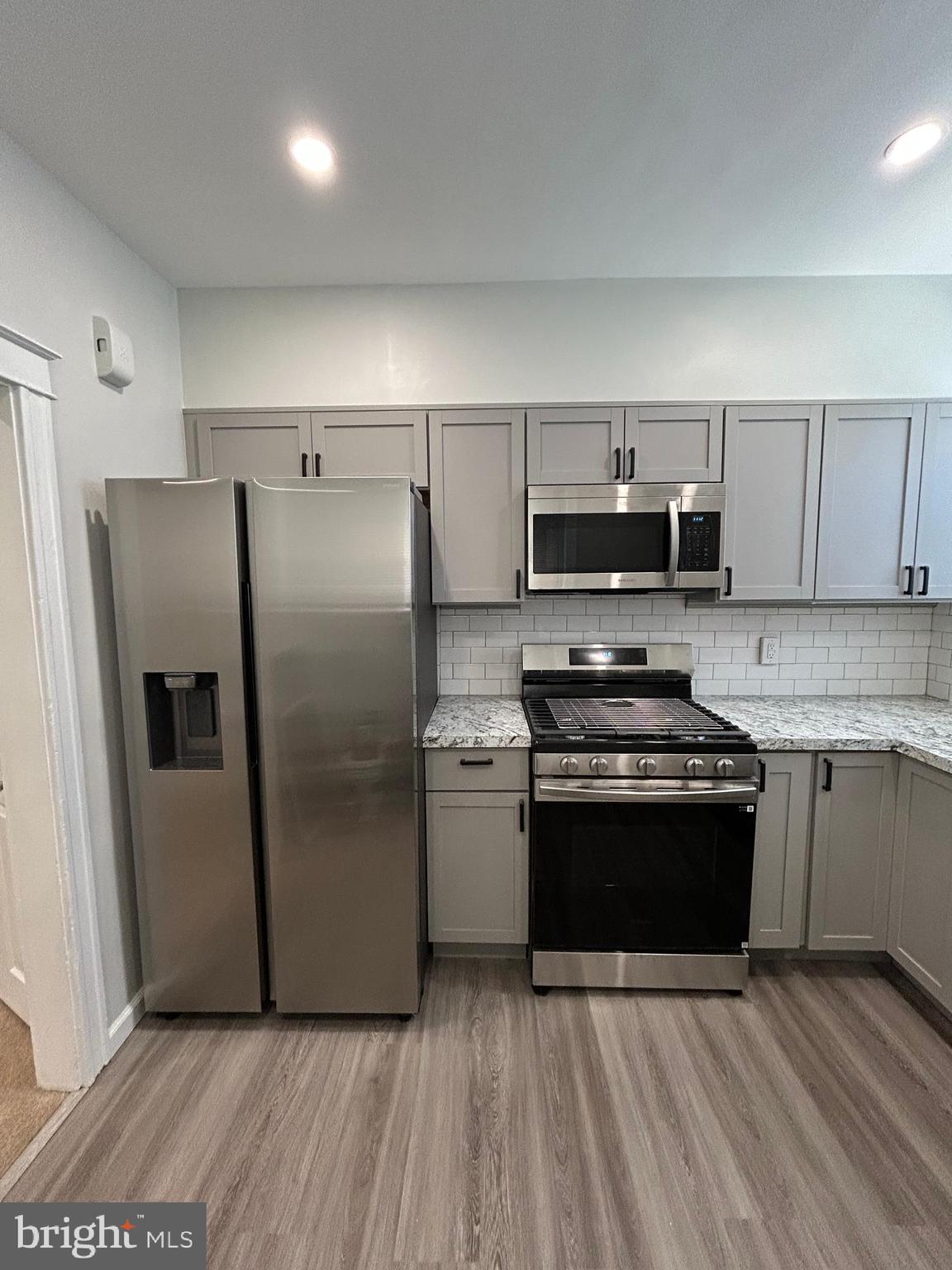 46 Lamport Road Upper Darby, PA 19082 - Photo 15 of 33 a kitchen with stainless steel appliances granite countertop a refrigerator stove and sink