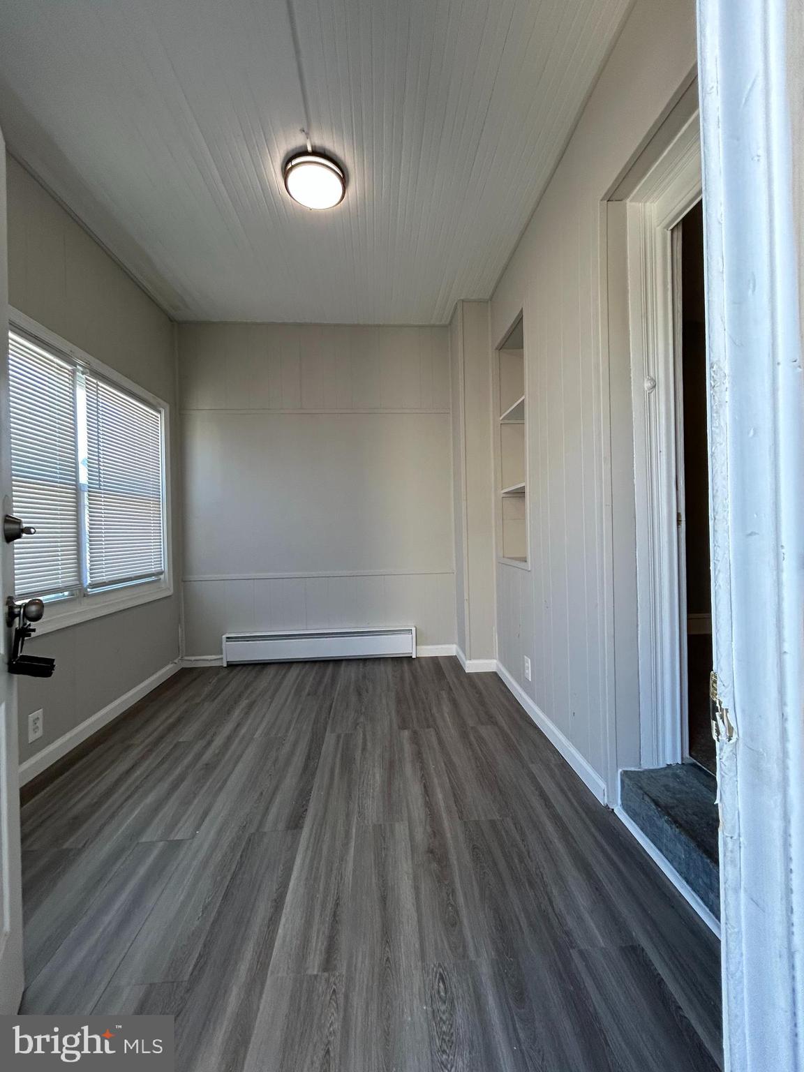 46 Lamport Road Upper Darby, PA 19082 - Photo 4 of 33 an empty room with wooden floor and windows