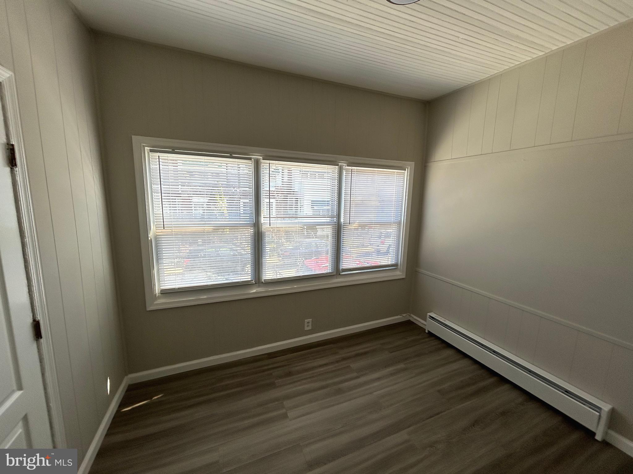 46 Lamport Road Upper Darby, PA 19082 - Photo 6 of 33 an empty room with wooden floor and windows