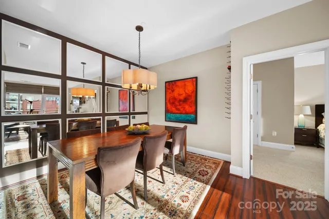 a dining room with furniture a chandelier and wooden floor