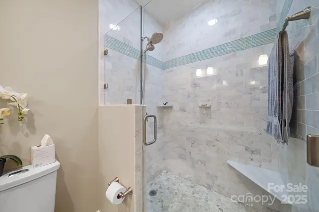 a bathroom with a shower and a sink