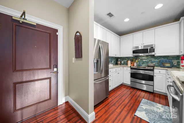 a kitchen with stainless steel appliances a refrigerator stove and microwave