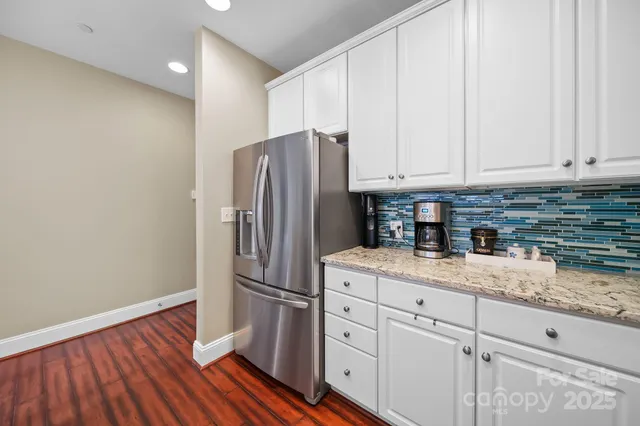 a kitchen with a refrigerator and cabinets