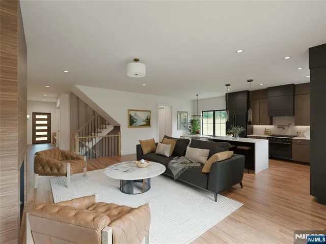 a living room with furniture and kitchen view