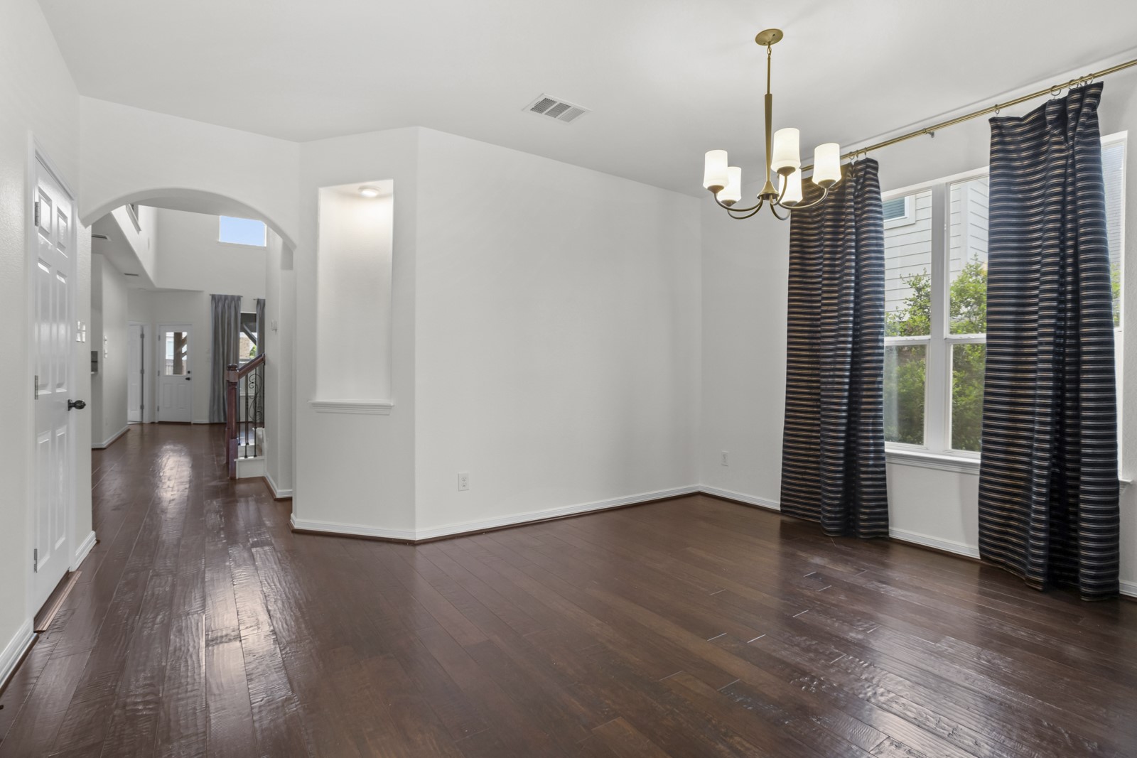 245 Razzmatazz Trail Buda, TX 78610 - Photo 4 of 37 Bright interior room with rich wood-finish flooring
