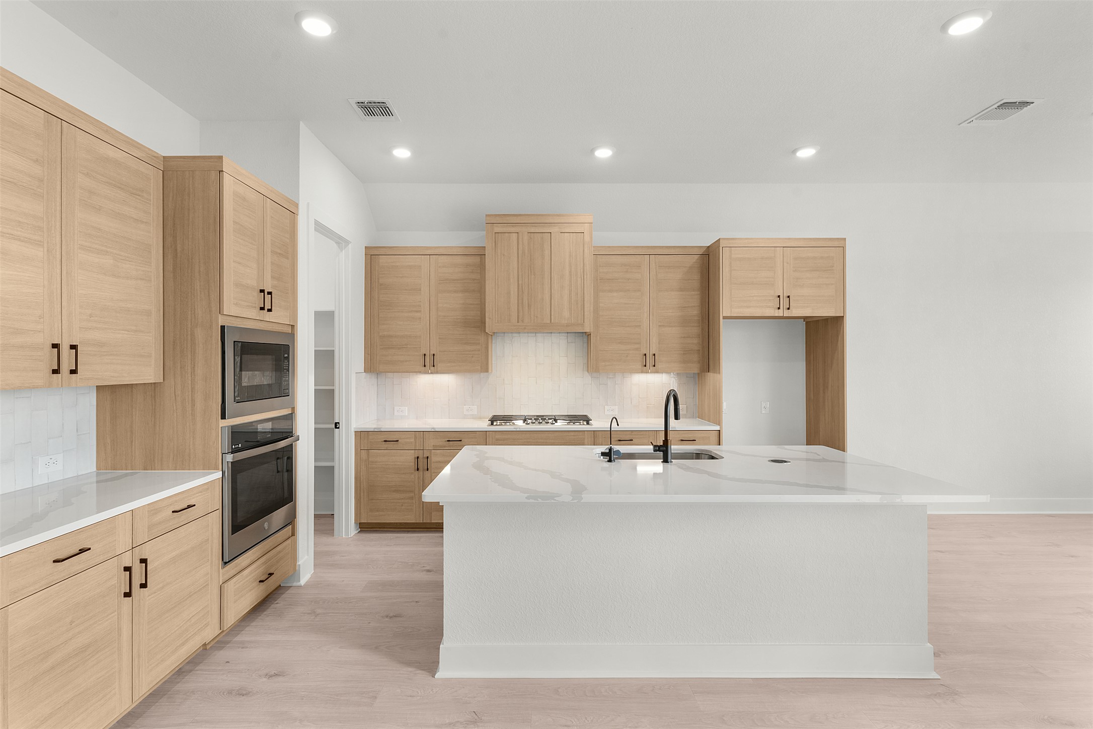 17316 Hope Bergman Road Pflugerville, TX 78660 - Photo 11 of 39 a kitchen with stainless steel appliances granite countertop a stove a sink and a refrigerator