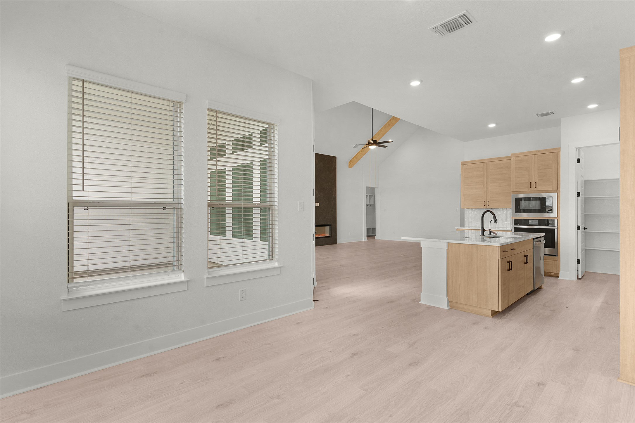 17316 Hope Bergman Road Pflugerville, TX 78660 - Photo 38 of 39 Kitchen featuring open floor plan, an island with sink, light brown cabinetry, appliances with stainless steel finishes, and recessed lighting