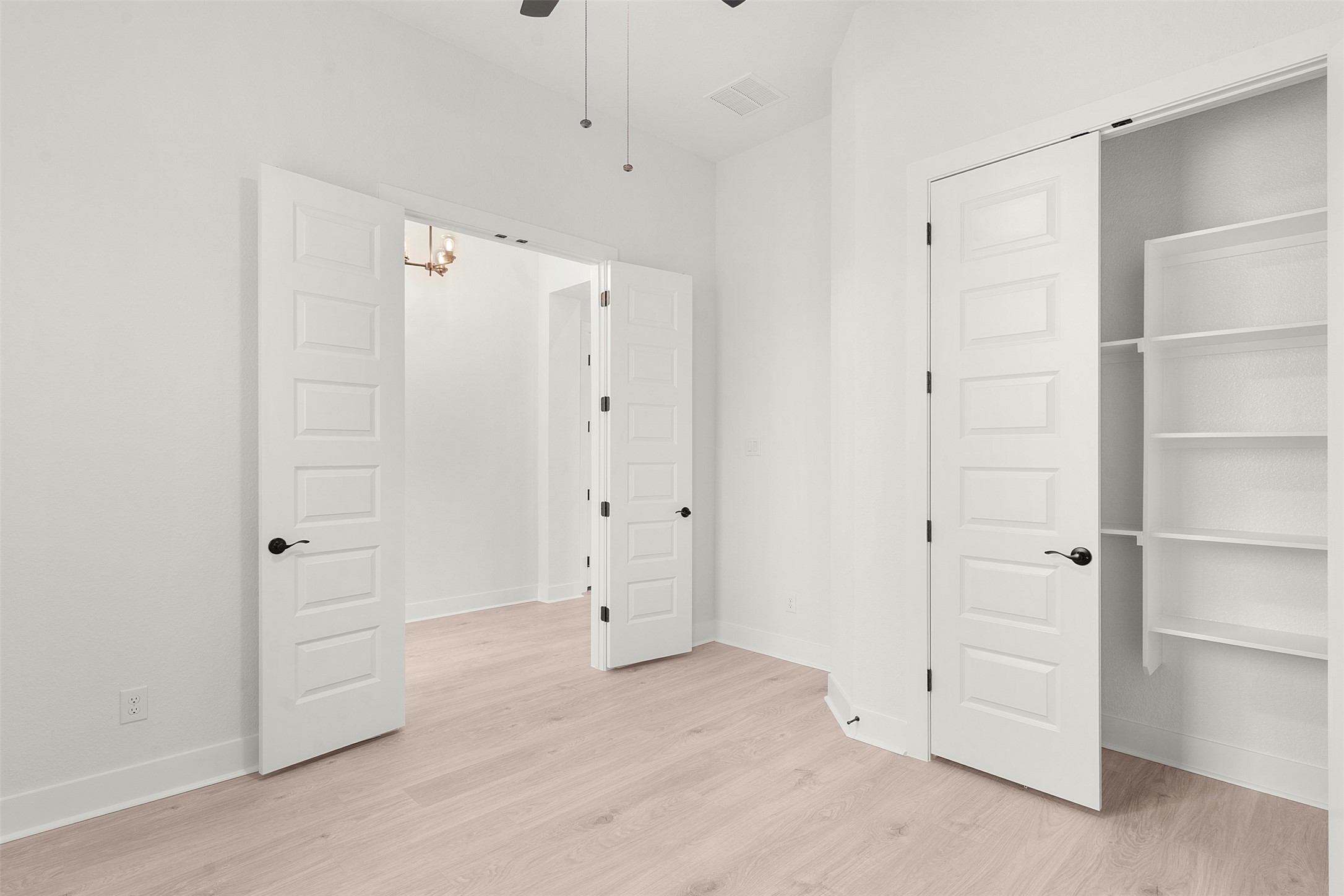 17316 Hope Bergman Road Pflugerville, TX 78660 - Photo 7 of 39 Unfurnished bedroom with light wood-style floors, ceiling fan, and a closet