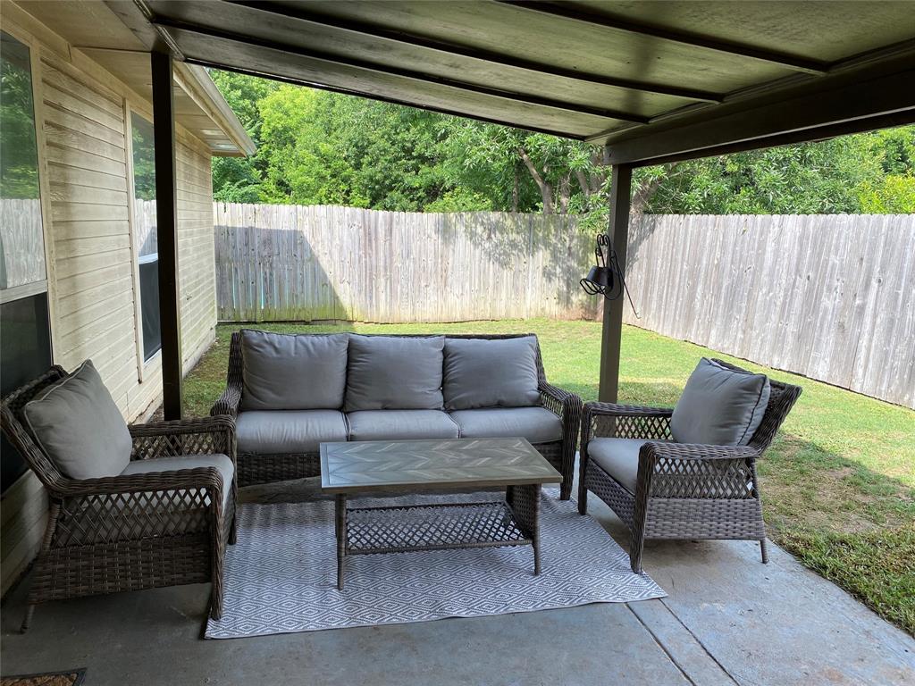 1100 Baker Street McKinney, TX 75069 - Photo 14 of 18 a outdoor living space with furniture and a black umbrella