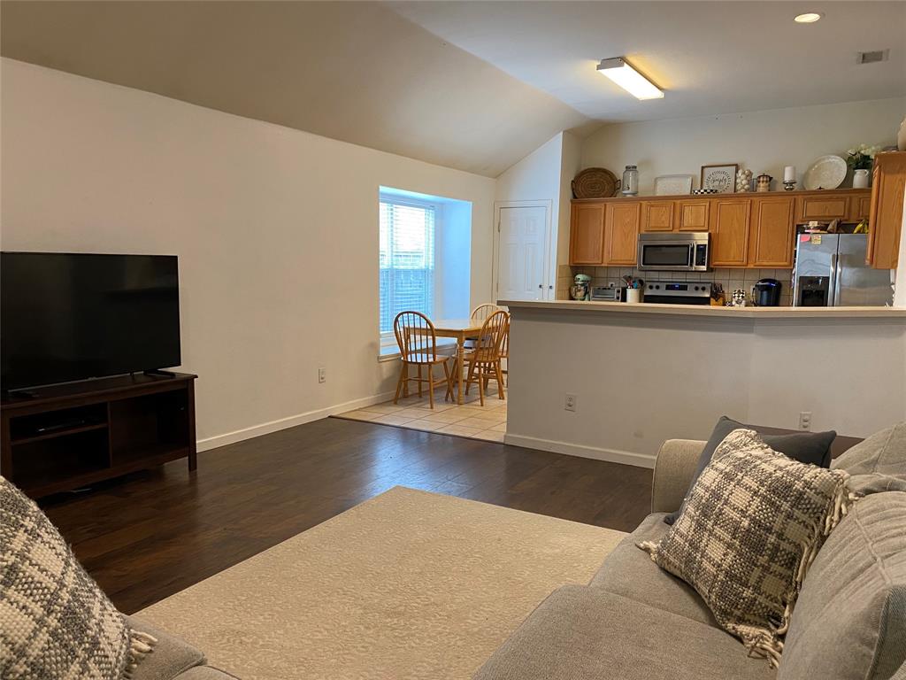 1100 Baker Street McKinney, TX 75069 - Photo 6 of 18 a living room with furniture and a flat screen tv
