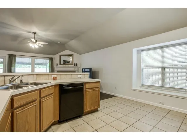 a kitchen with a sink cabinets and window
