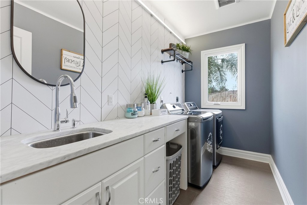 29131 Bouquet Canyon Road Silverado, CA 92676 - Photo 63 of 74 2nd floor laundry room with sink and storage