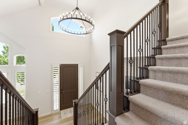 1712 Somerset Ridge Drive Draper, UT 84020 - Photo 32 of 76 Grand entryway featuring a vaulted ceiling and a decorative chandelier