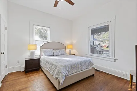 a bedroom with a bed lamp and a window