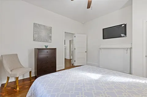 a bedroom with a bed and a television