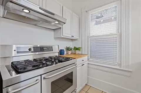 a white stove top oven sitting inside of a kitchen