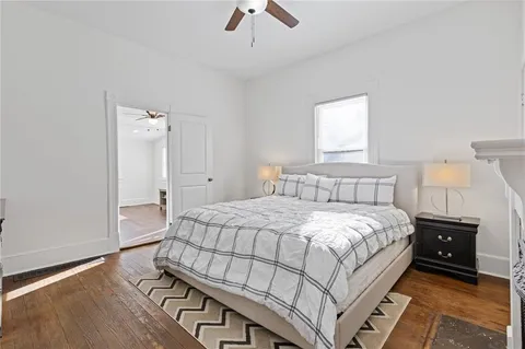 a bedroom with a bed and a night stand