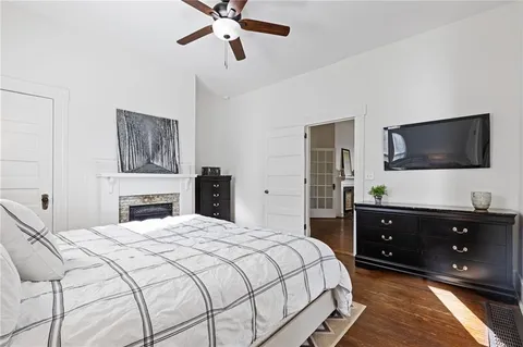 a bedroom with a bed and a flat tv screen on dresser