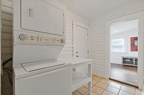 a view of washer and dryer with bathroom in the background