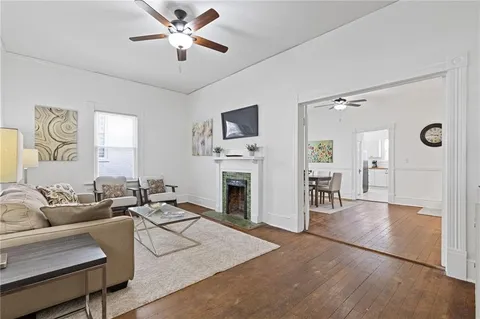 a living room with furniture a fireplace and a flat screen tv